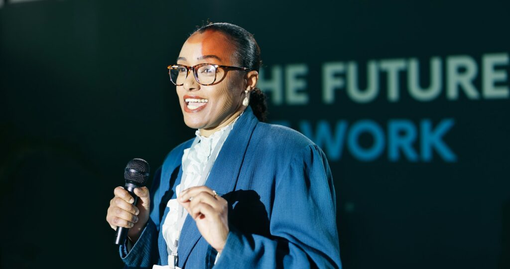 Black woman, mic and speech at conference for public speaking, presentation and international conve